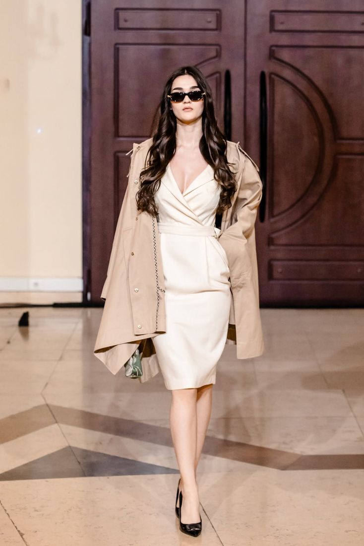 Look 16: Cream wrap dress with a trench worn off the shoulders