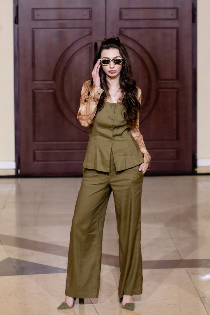 Look 22: Olive vest and trousers over a printed shirt