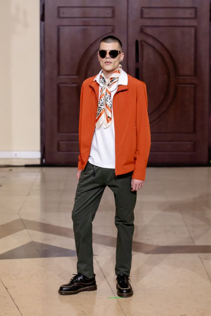Look 25: Orange zip jacket, silk scarf, olive trousers